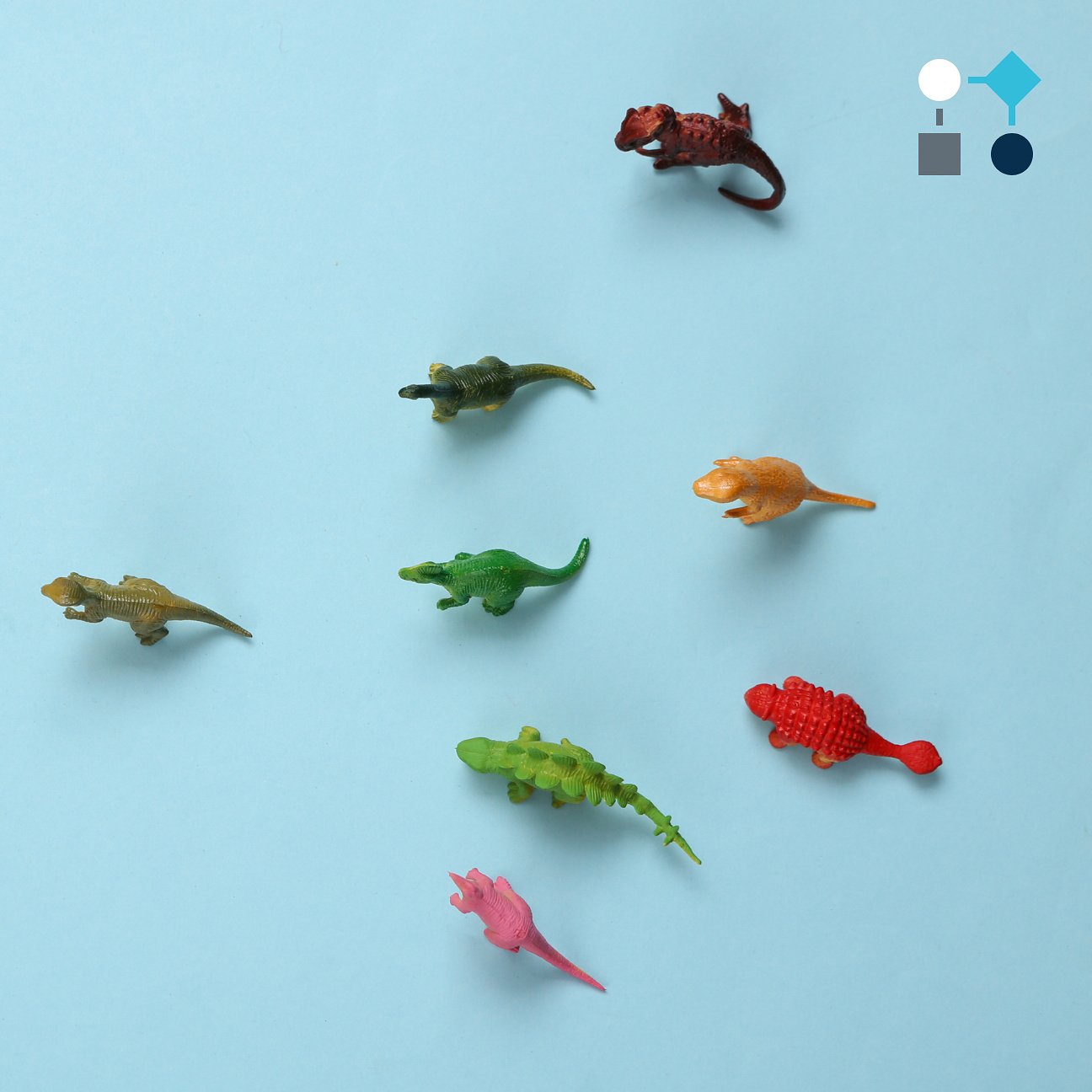 A colorful assortment of small plastic animals set on a blue surface